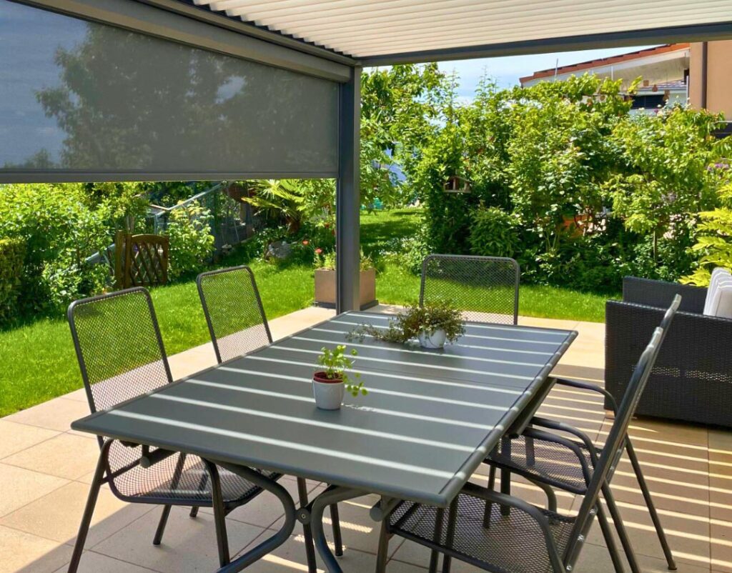 en dessous d'une pergola bioclimatique avec store semi abaissé